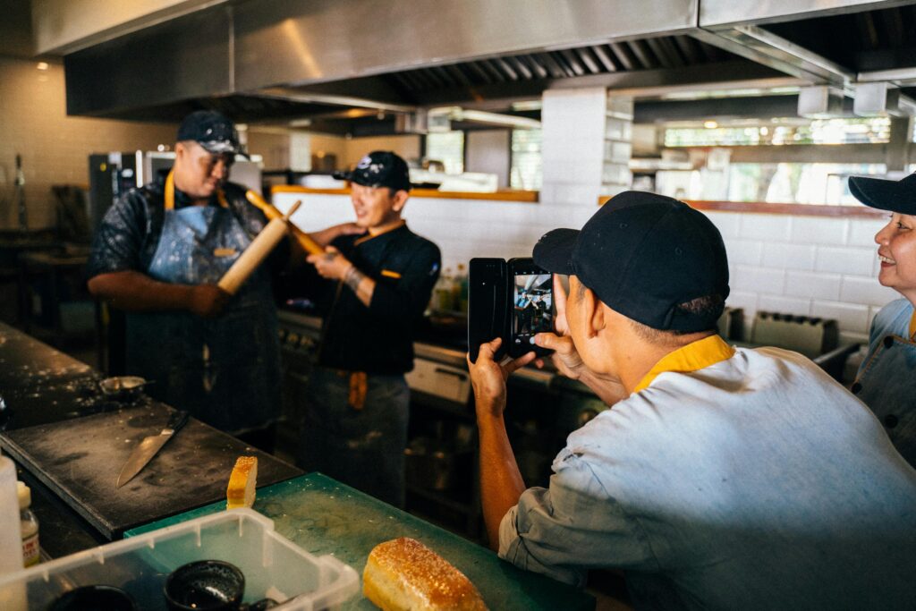 pexels photo 6937430 6937430 2 Chefs enjoy a playful moment during work in a vibrant restaurant kitchen.